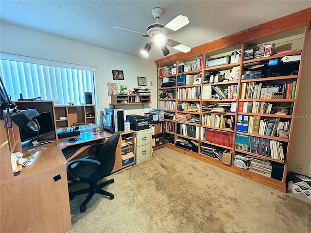 carpeted home office featuring ceiling fan and a textured ceiling