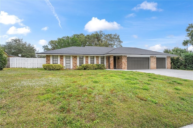 ranch-style home with a garage and a front yard