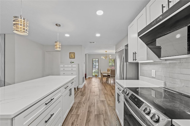 kitchen featuring a chandelier, white cabinetry, hanging light fixtures, and stainless steel appliances