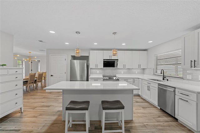 kitchen featuring a center island, white cabinetry, and stainless steel appliances