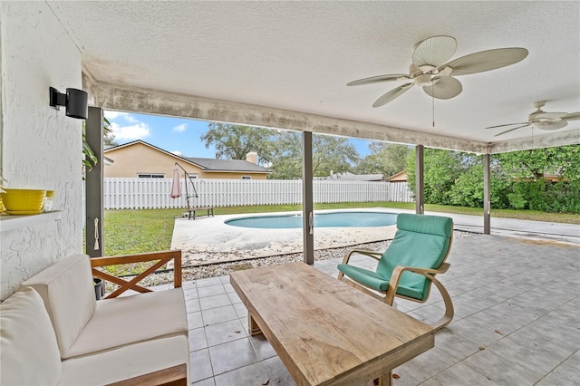 view of patio featuring a fenced in pool and ceiling fan