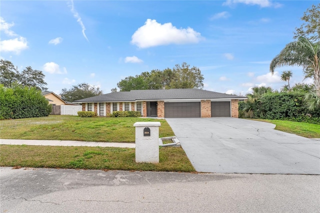 single story home with a garage and a front yard