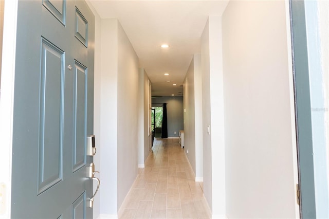 corridor with light tile patterned floors