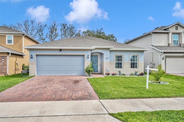 view of front of property with a garage, a front lawn, decorative driveway, and stucco siding