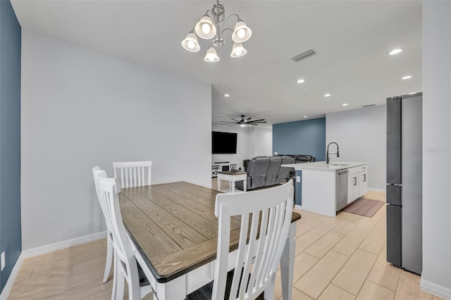 dining space with ceiling fan with notable chandelier, baseboards, visible vents, and recessed lighting