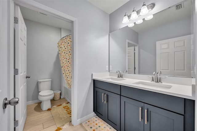 bathroom featuring double vanity, visible vents, toilet, shower / tub combo with curtain, and a sink