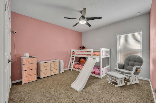 carpeted bedroom with ceiling fan and baseboards