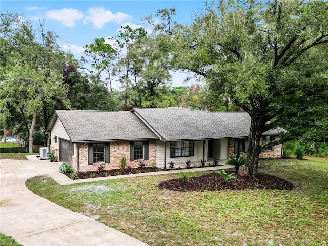 view of front of house featuring a front yard and a garage