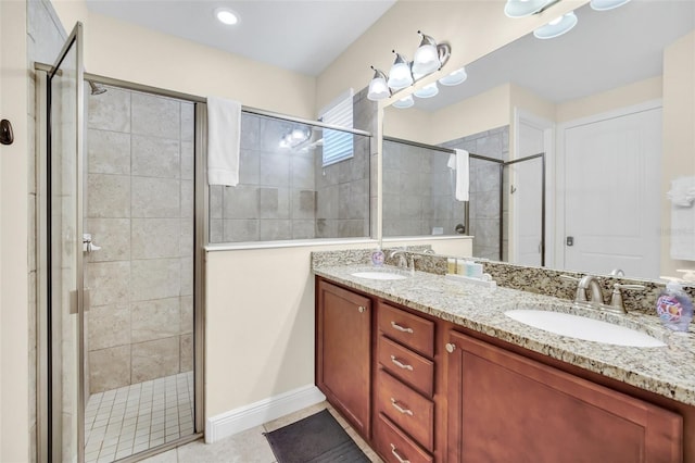 bathroom with tile patterned floors, vanity, and walk in shower