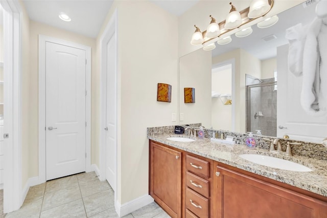 bathroom with tile patterned flooring, vanity, and walk in shower