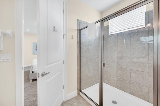 bathroom featuring tile patterned flooring and a shower with shower door