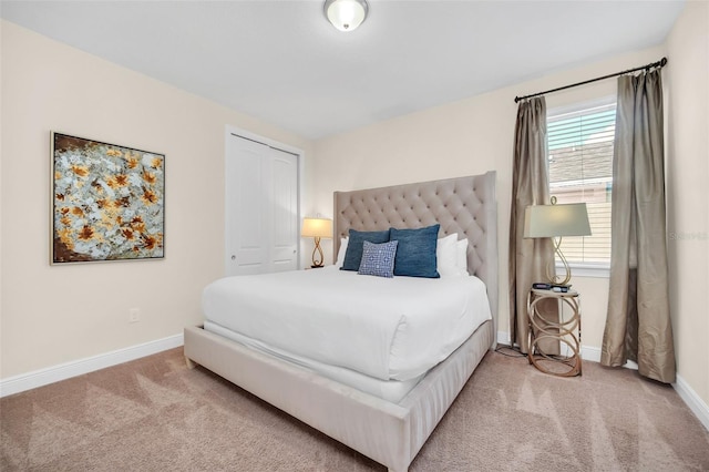 carpeted bedroom featuring multiple windows and a closet