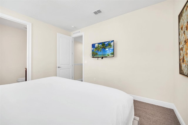 bedroom featuring carpet flooring and ensuite bathroom