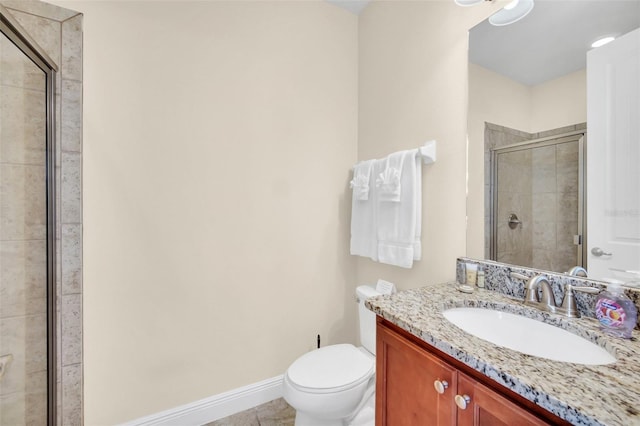 bathroom with tile patterned floors, vanity, toilet, and a shower with shower door