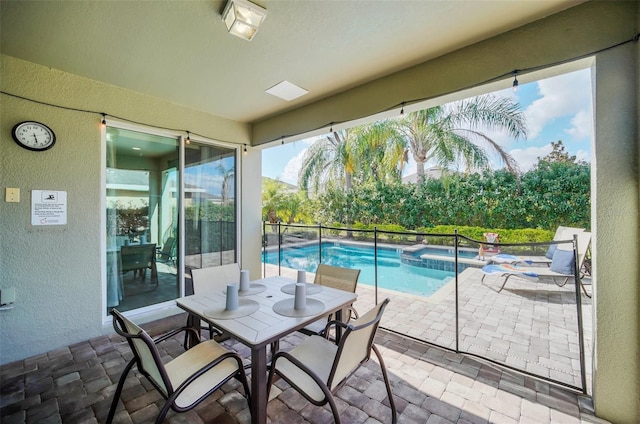 view of patio / terrace with a swimming pool with hot tub