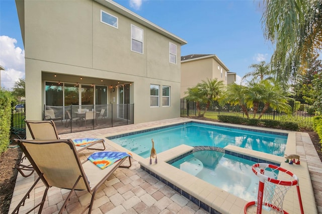 view of swimming pool with a patio area and an in ground hot tub