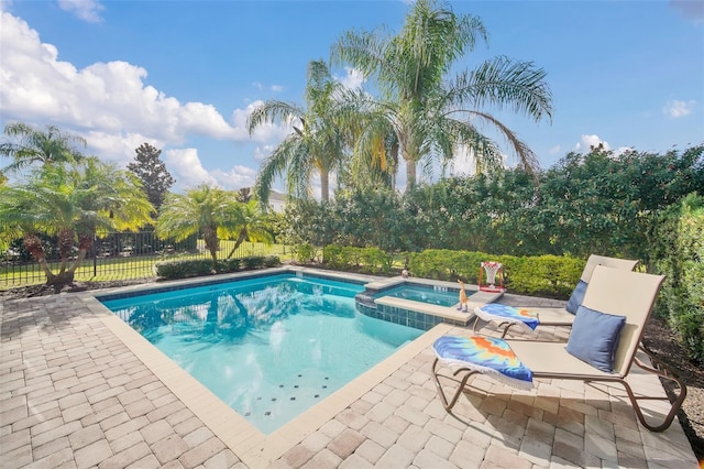 view of swimming pool with a patio area and an in ground hot tub