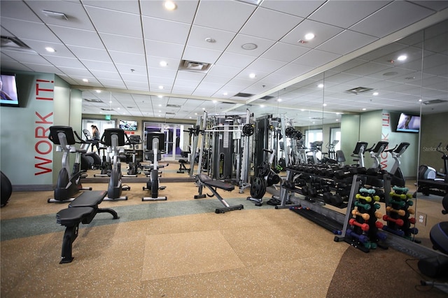 exercise room featuring a drop ceiling and plenty of natural light