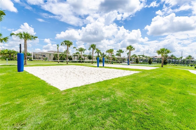 view of home's community with volleyball court and a lawn