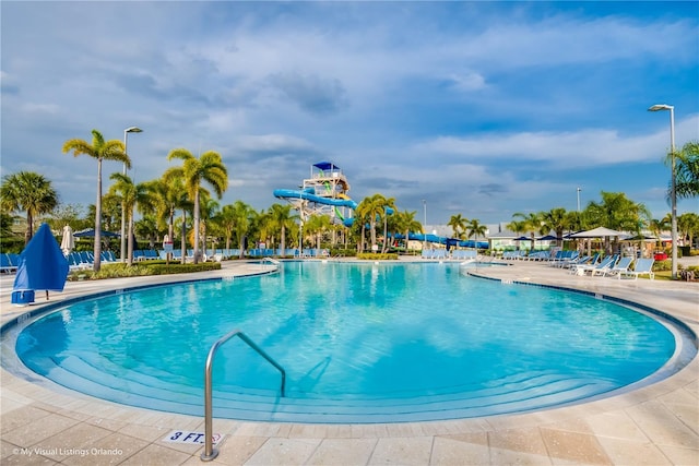 view of swimming pool featuring a patio area and a water slide