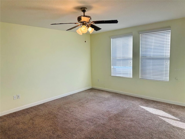 carpeted spare room featuring ceiling fan