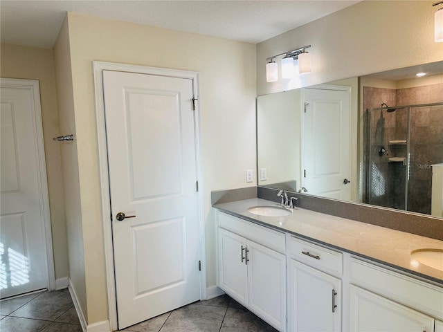 bathroom featuring vanity, tile patterned floors, and a shower with shower door