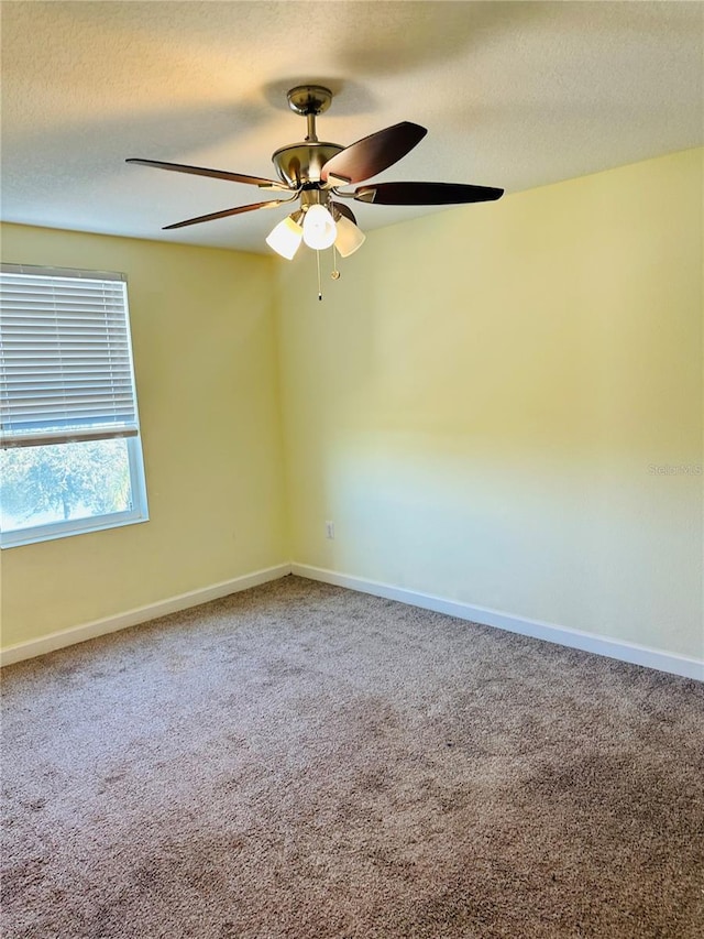 unfurnished room featuring carpet floors and ceiling fan