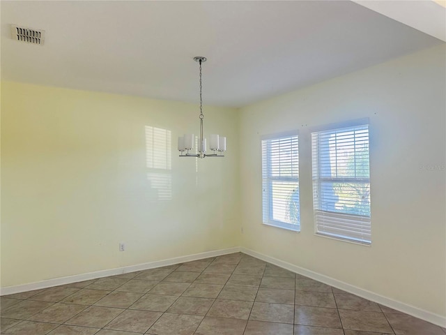 unfurnished dining area with tile patterned floors and a chandelier