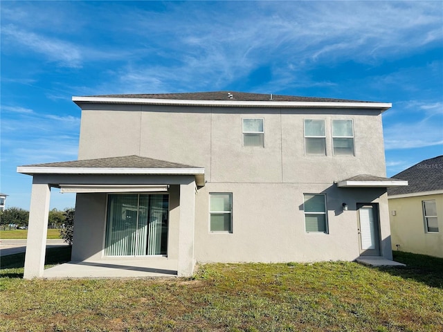 rear view of house featuring a yard