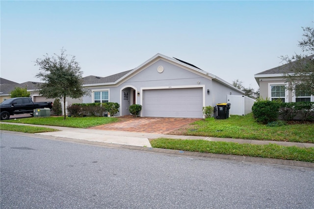 single story home with a front lawn and a garage