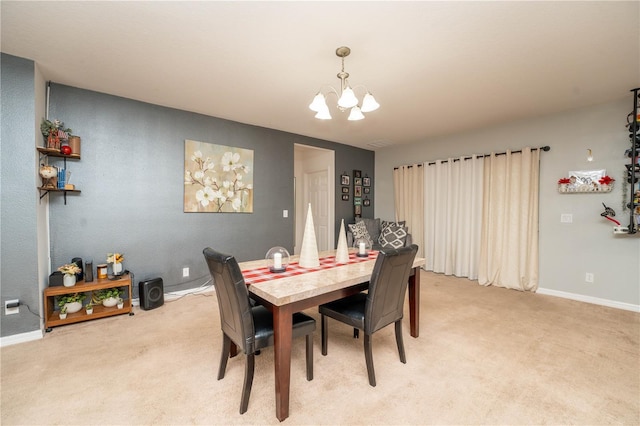 dining room with light carpet and a notable chandelier