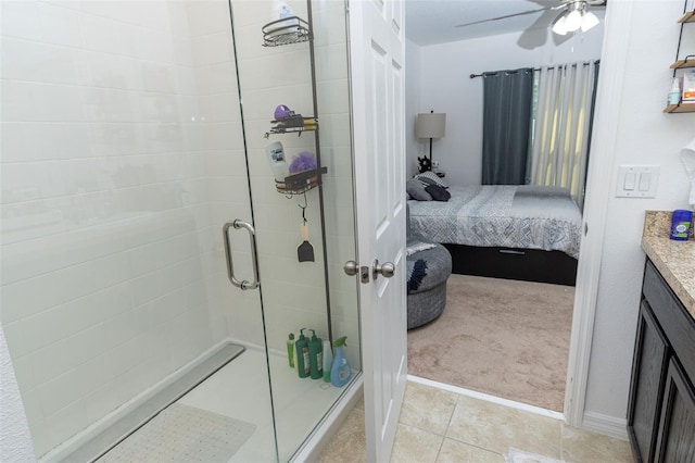 bathroom featuring ceiling fan, tile patterned flooring, vanity, and a shower with shower door