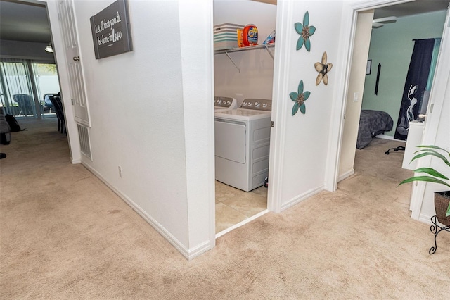 washroom featuring washer and dryer and light colored carpet