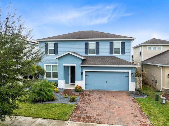 front facade with a front lawn and a garage