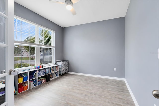 interior space featuring hardwood / wood-style floors and ceiling fan