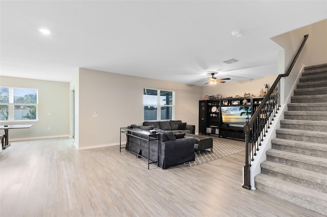 living room with ceiling fan and light hardwood / wood-style floors