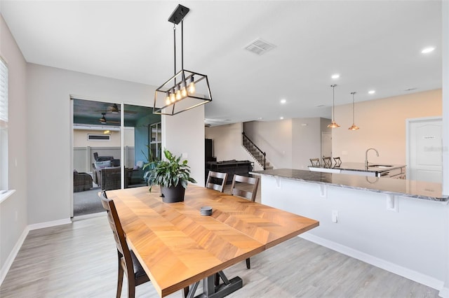 dining area featuring light hardwood / wood-style floors and sink