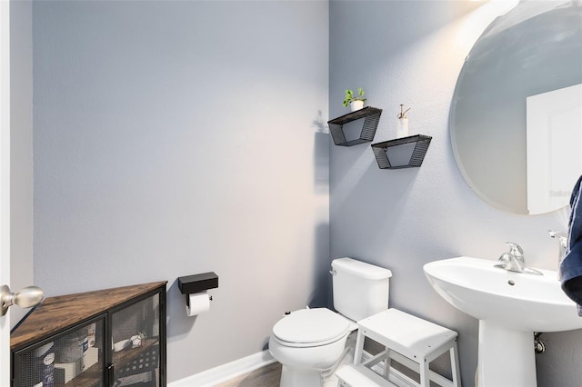 bathroom featuring hardwood / wood-style floors and toilet