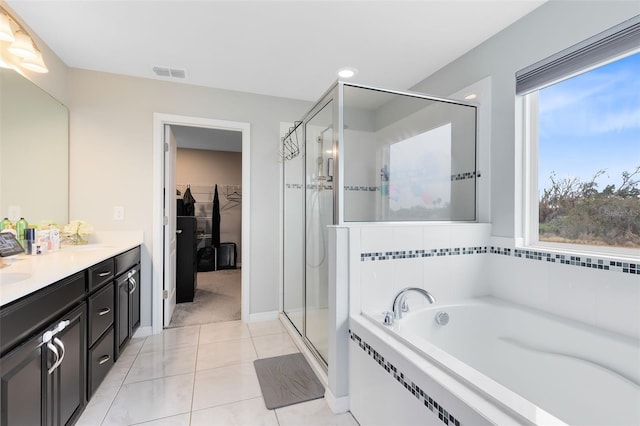 bathroom with tile patterned floors, vanity, and independent shower and bath