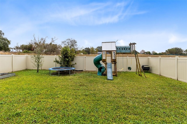 view of yard featuring a playground and a trampoline