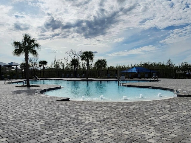 view of swimming pool with a patio area and pool water feature