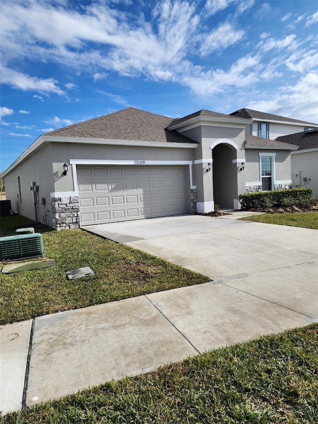 view of front of home featuring a garage and central AC unit