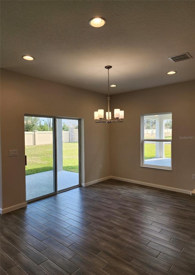 spare room with an inviting chandelier