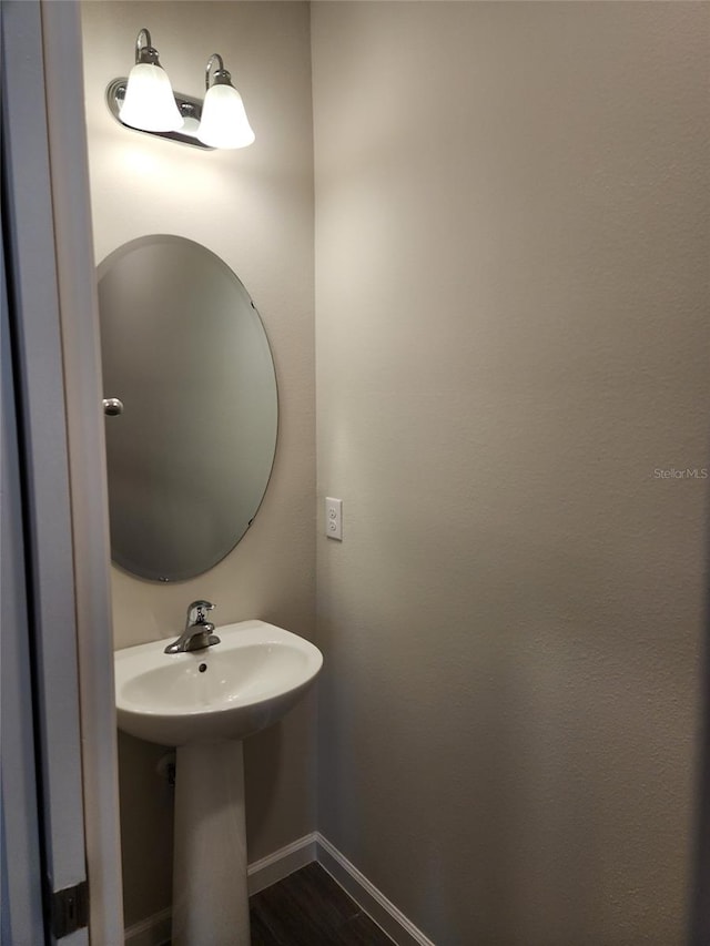 bathroom with hardwood / wood-style floors and sink