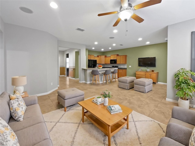 living room featuring ceiling fan and light tile patterned flooring