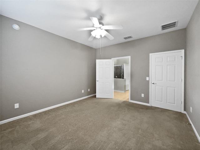 unfurnished bedroom with dark colored carpet and ceiling fan