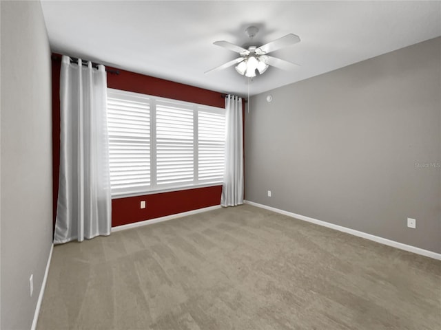 unfurnished room with ceiling fan and light colored carpet