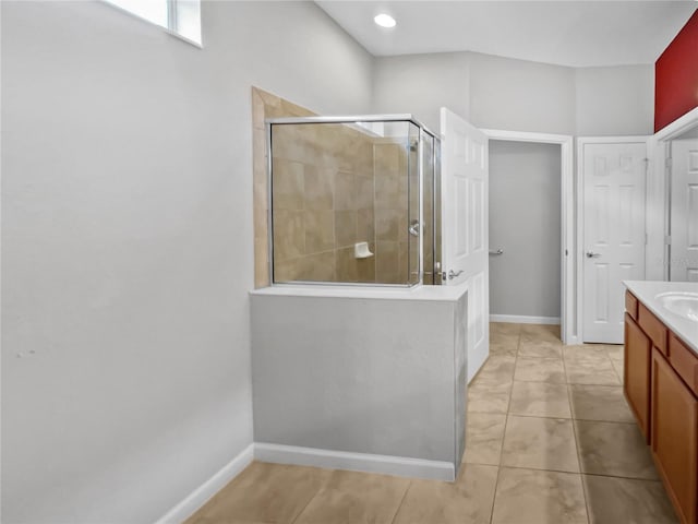 bathroom featuring tile patterned flooring, vanity, and an enclosed shower