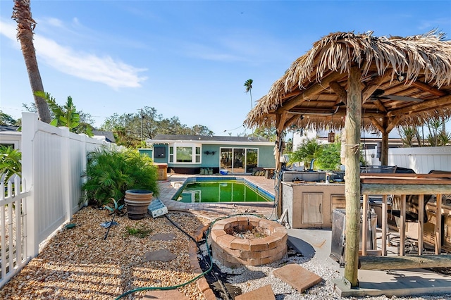 view of pool featuring a fire pit and a patio