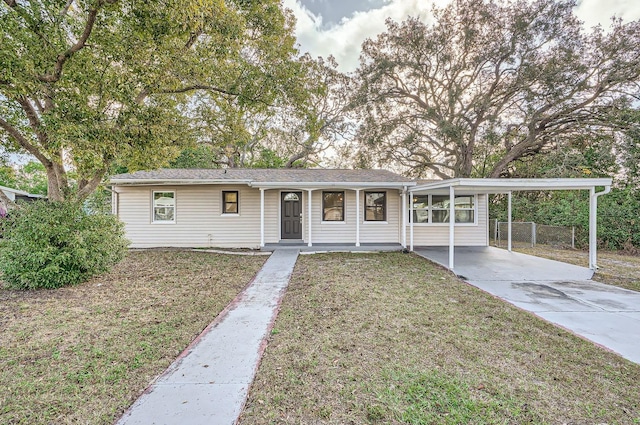 ranch-style home featuring a front yard and a carport